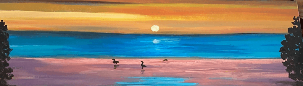 Beautiful piece of coastal wall art - a panoramic view of the coast during a golden sunset