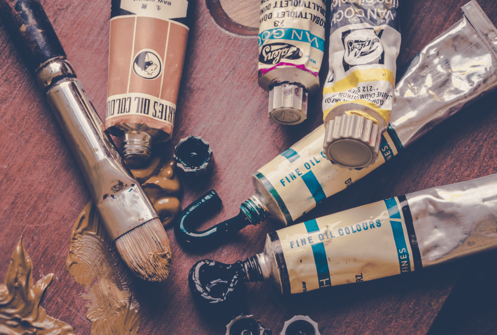 tubes of acrylic paint on a wooden table
