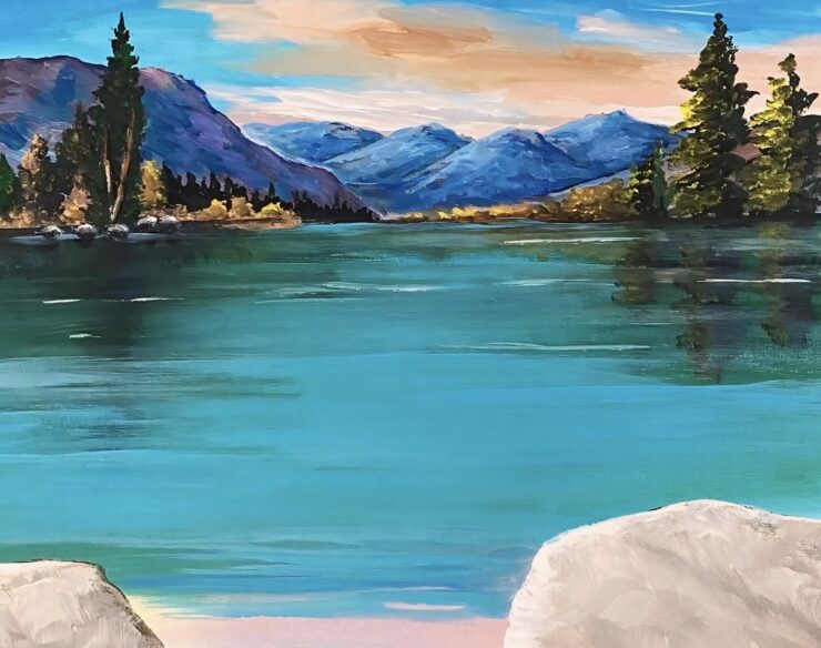 A photo of an original painting by Trese Judd, titled "Lakefront Serenade," depicting a gorgeous nature shot of a turquoise lake, with dreamy blue mountains and pine trees in the distance.