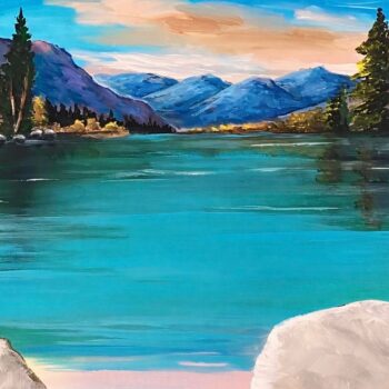 A photo of an original painting by Trese Judd, titled "Lakefront Serenade," depicting a gorgeous nature shot of a turquoise lake, with dreamy blue mountains and pine trees in the distance.