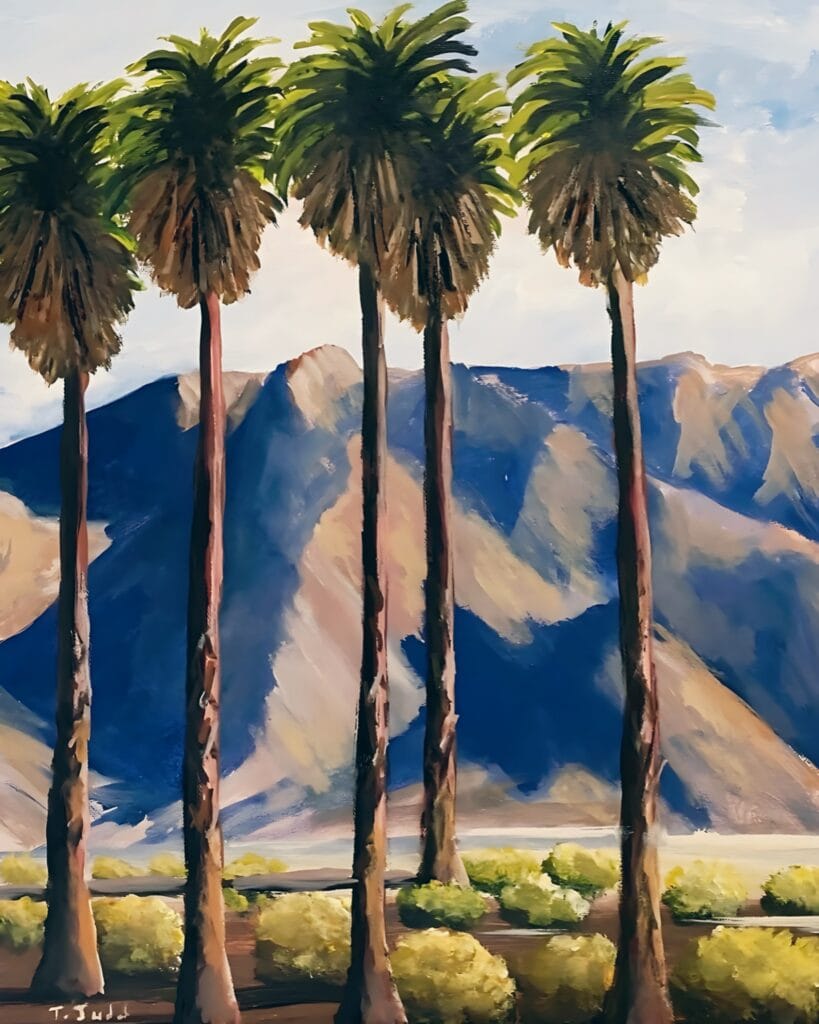 Painted Palms by contemporary artist Trese Judd features five tall, slender palm trees in the Palm Springs, California. In the background, majestic mountains in hues of taupe and pale sienna, with shadows of midnight blue. The scenery is completed by s pale blue sky and some bushes lining the bottom of the canvas.